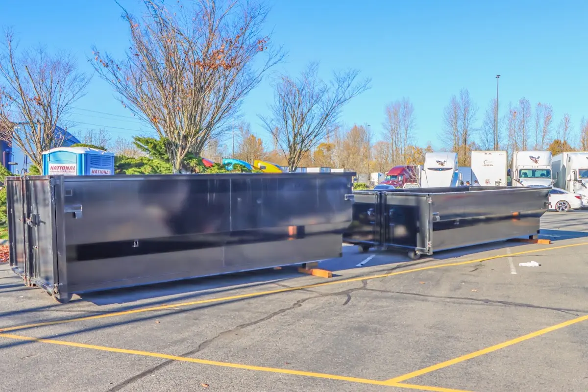 Professional dumpster rental service with roll-off container on residential driveway in Wilton